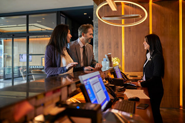 Business people at reception desk in hotel lobby