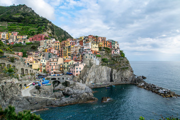 Fototapeta na wymiar Beautiful colorful cityscape on the mountains over Mediterranean sea, Europe, Cinque Terre, traditional Italian architecture.