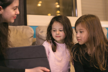 Mother doing Lessons with Children on a Tablet