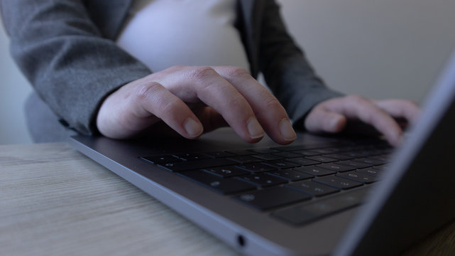 Hand touching the keyboard in laptop