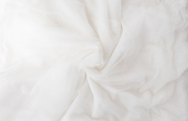  Top view White crumpled tulle and grapefruit, contemporary art in pastel colors. Still life with shadow and sunbeams