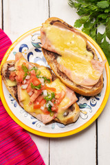 Mexican molletes with ham and cheese on white background