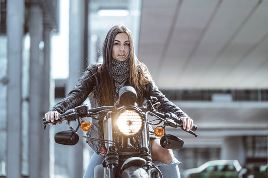 Young Beautiful Woman Riding Motorbike In The City