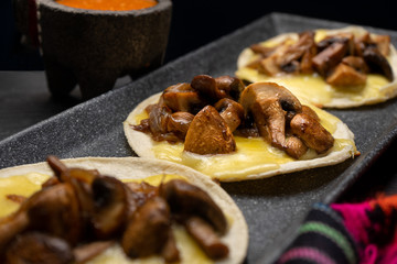 Mexican quesadillas with mushrooms on dark background