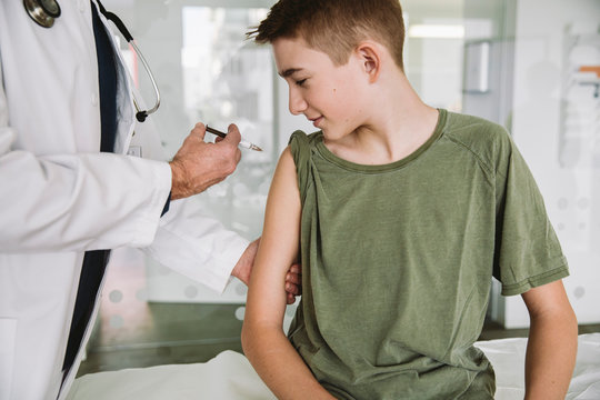 Doctor Injecting A Vaccine Into Teenager?s Arm