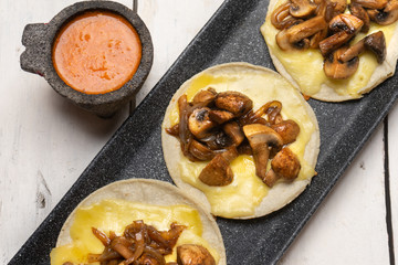 Mexican quesadillas with mushrooms on white background