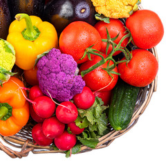Vegetables in a wicker basket. Harvest. Isolate on white background