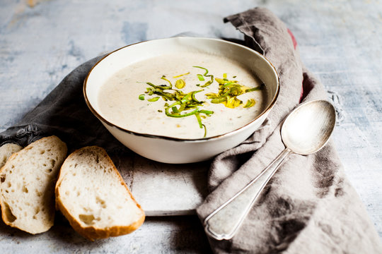 Bowl of cheese soup with bell pepper, leek and minced meat