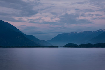 Sunset at Lake Comersee, mountains in background, clouds in sky, Italy.