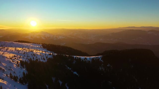Aerial landscape view from the Ceahlau Mountains National Park and Toaca peak at sunset in the winter season. Aerial view from the drone