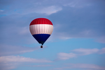 Colorful hot air balloon flying in blue sky