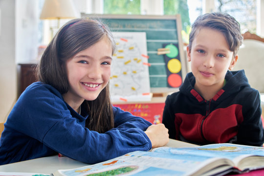 Brother and sister learing at home during school closure