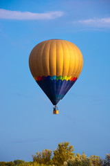 Colorful hot air balloon flying in blue sky