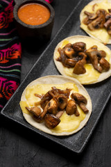 Mexican quesadillas with mushrooms on dark background