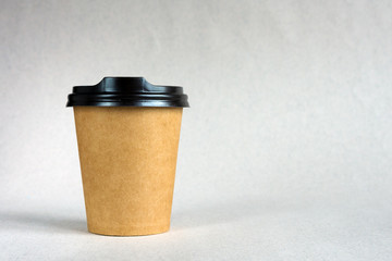 Disposable paper cups for coffee on a beige background. Takeaway coffee concept.