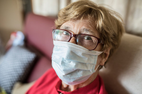 Senior woman wearing protective maks and looking at camera