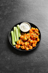Cauliflower buffalo wings with celery and sauce