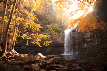 Fototapeta na wymiar Waterfall surrounded by autumn foliage