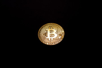 gold coin bitcoin on a black background