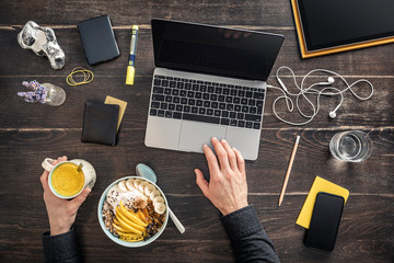 Overhead view of man working at desk in home office