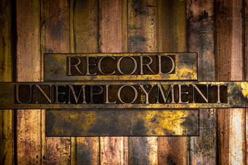 Photo of real authentic typeset letters forming Record Unemployment text on vintage textured grunge...