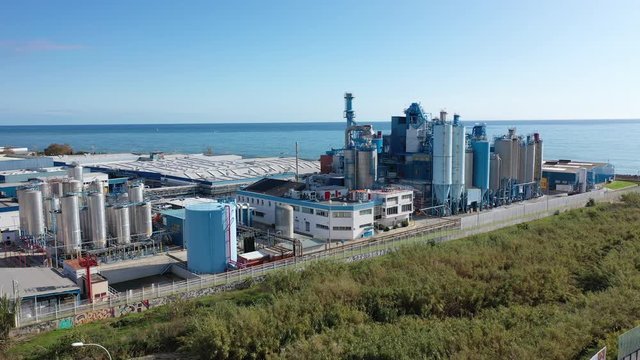 Aerial panoramic view of chemical process plant on Mediterranean coast near Mataro, Catalonia, Spain