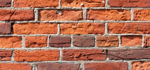 Fototapeta premium A fragment of a wall made of old red bricks, a conceptual background.