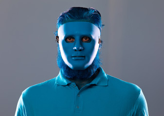 portrait of a strange man in a blue mask