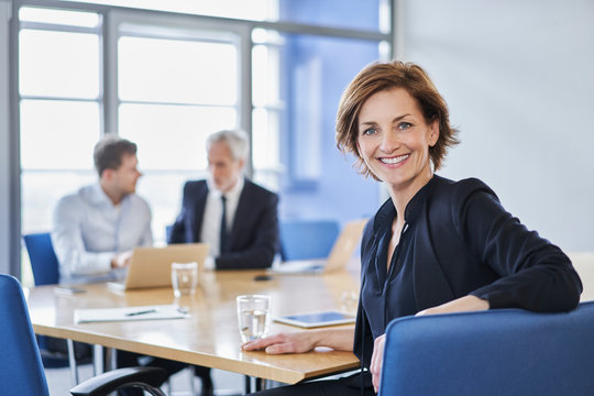 Portrait of smiling businesswoman during a meeting in office