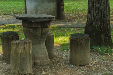 Rustic wooden table and four logs as chairs, countryside style