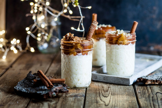 Jars of rice pudding with cinnamon and roasted plums