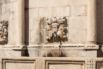 Architectual details of the big Onofrio fountain designed by the Italian architect Onofrio di Giordano della Cava at Stradun, the large street in the Old Town of Dubrovnik, Dalmatia, Croatia