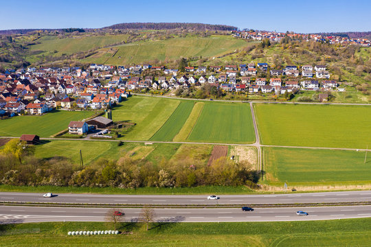 Germany, Baden-Wurttemberg, Remstal, Aerial view of traffic on Bundesstrasse B29 with town in background