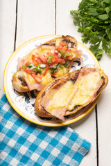 Mexican molletes with ham and cheese on white background