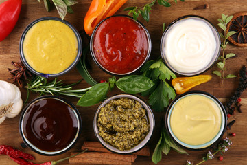 Sauces Assortment. Set of various sauces in bowls with ketchup, mayonnaise, pesto and mustard. Variety of induvidual marinades.