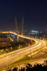 Golden bridge in Vladivostok at night. Night traffic. Golden Bridge in sunset, Vladivostok, Russia.