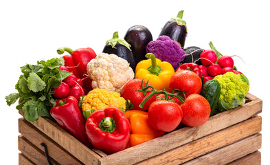 Vegetables in a wooden box. Harvest. Isolate on white background