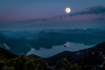 Mountain panorama of the Alps under a full moon