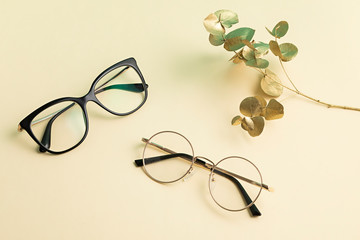 Stylish eyeglasses over pastel  background. Optical store, glasses selection, eye test, vision...