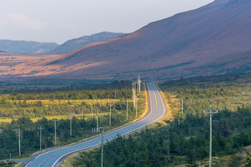 Twisting road running beside the Tablelands in the Gros Morne National Park in Newfoundland, Canada
