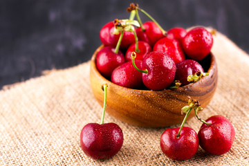 Fresh cherry on black wooden table. Ripe sweet berries in droplets of water - Powered by Adobe