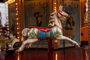 Old vintage horse carousel ride in the city center of Eindhoven on the market, an authentic retro merry go round with lights