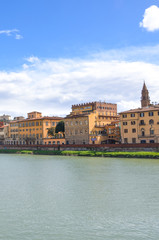 Fototapeta na wymiar Cityscape of Florence, Tuscany, Italy. Historical center located along the Arno river. Blue sky and clouds over the Italian city. Vertical photo.