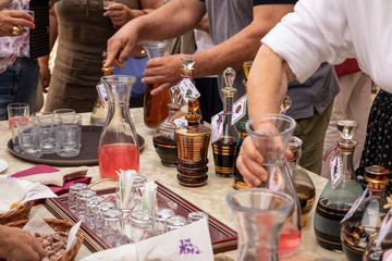 Collection of traditional glass gold painted carafes filled with strong typical Croatian liqueurs,...