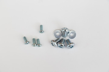Metal screws, bolts, washers and nuts isolated on white background. 