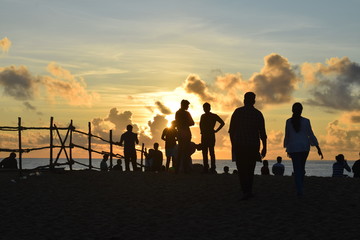 Fototapeta na wymiar group of people walking on sunset IN BEACH