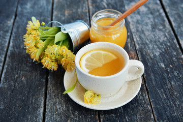 linden flowers, herbal medicine, Cup of healthy tea with honey and lemon. alternative or...