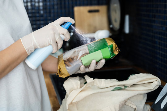 Woman Sanitizing Groceries And Other Food