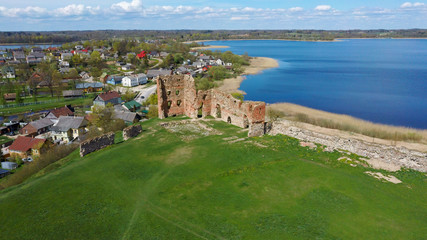 Aerial View of the Ludza Medieval Castle Ruins on a Hill Between Big Ludza Lake and Small Ludza Lake. The Ruins of an Ancient Castle in Latvia.