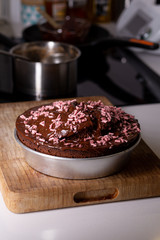 Homemade chocolate cake cooked on a domestic kitchen on a metal plate